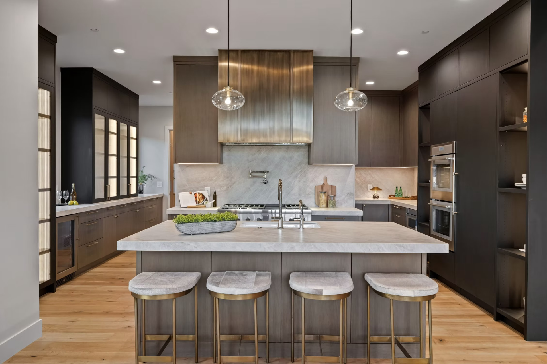 Lune wide plank European oak flooring beneath a marble island and brass range hood — Red Mountain project