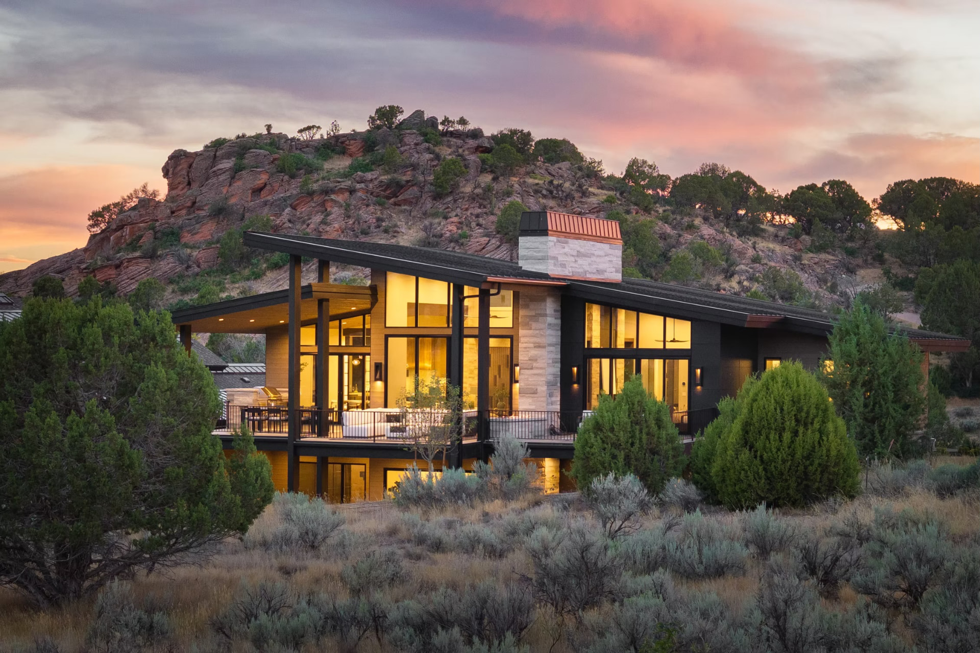 Red Mountain residence at sunset, cantilevered against a red rock ridge