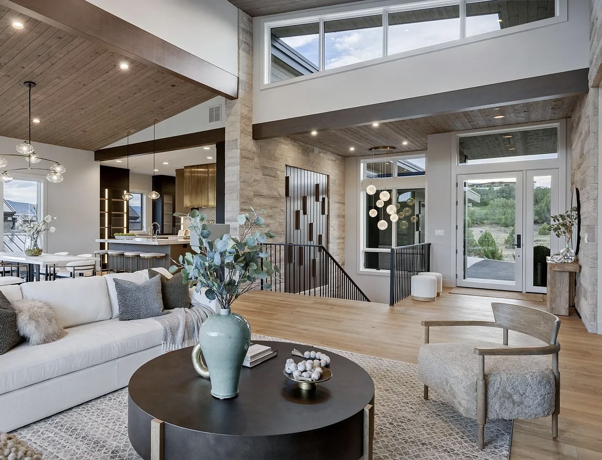 Lune wide plank European oak flooring in the Red Mountain great room, framed by stone and mountain light