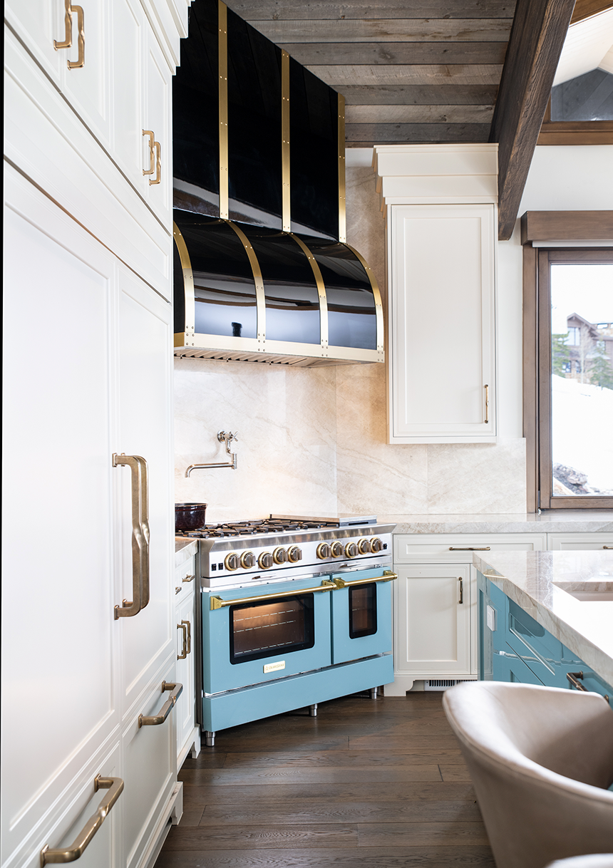 Brina wide plank European oak flooring beneath a blue range and black-and-brass hood